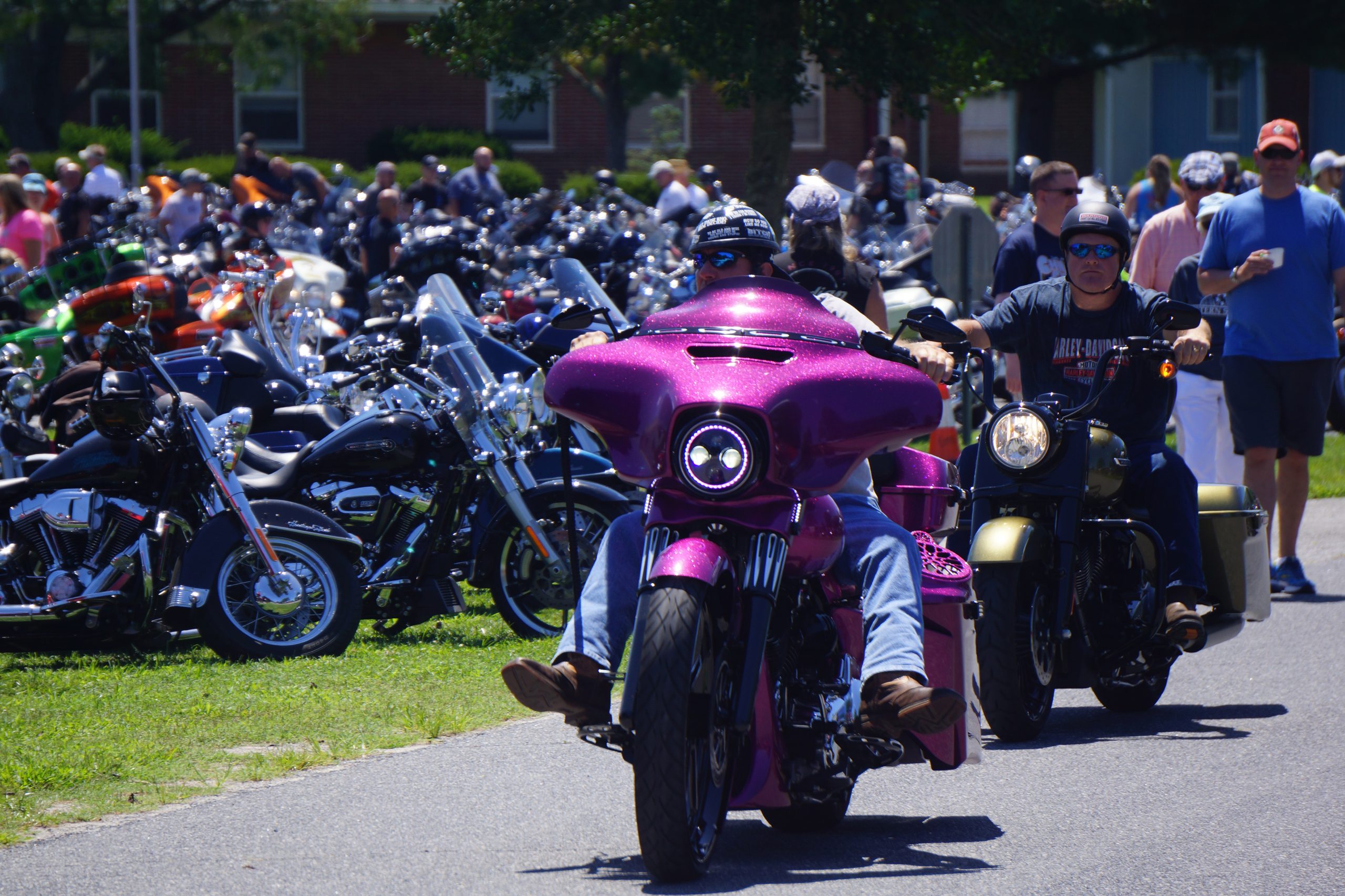 Man riding sparkly purple motorcycle.