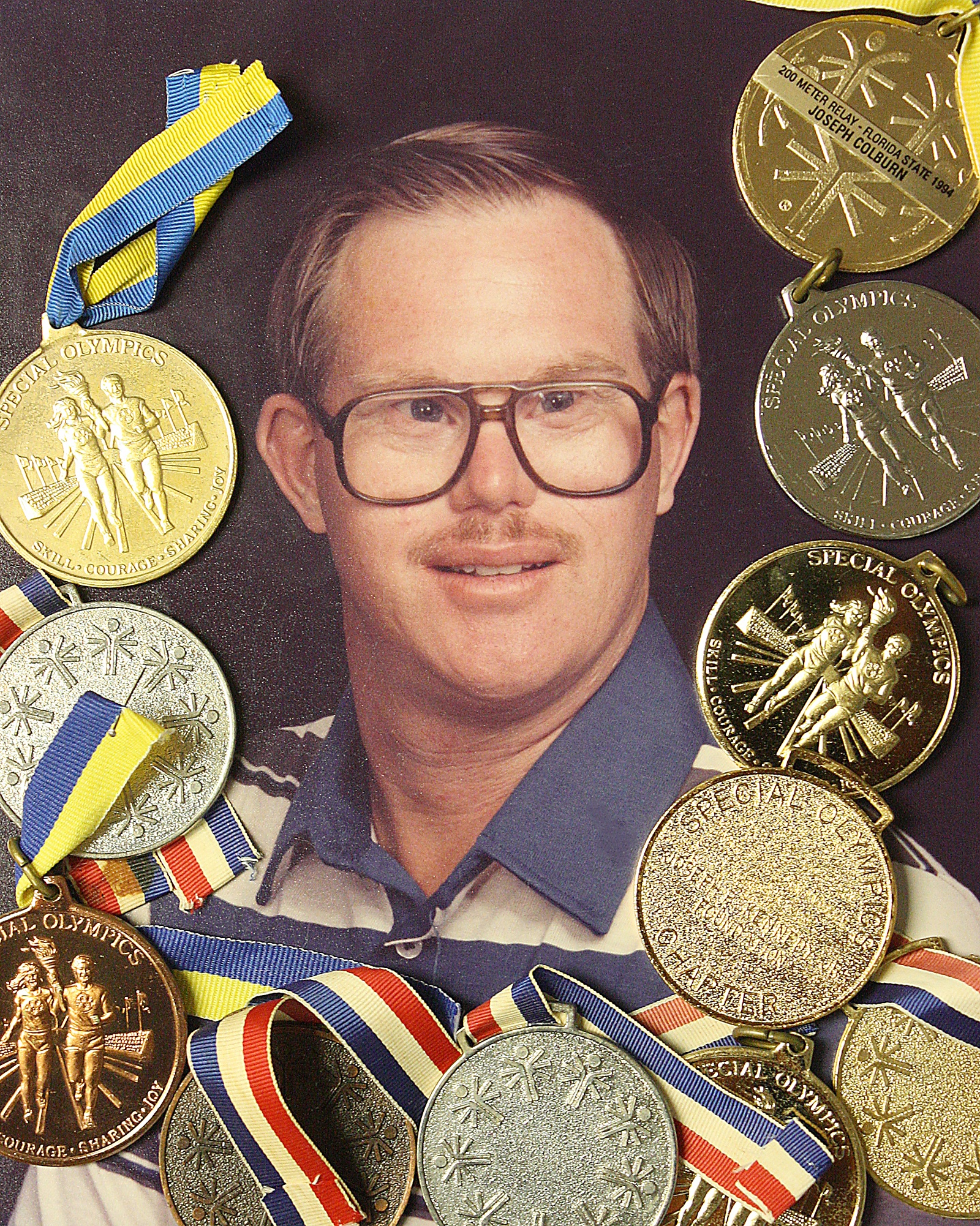 Display of Special Olympic metals with photo of Joey.