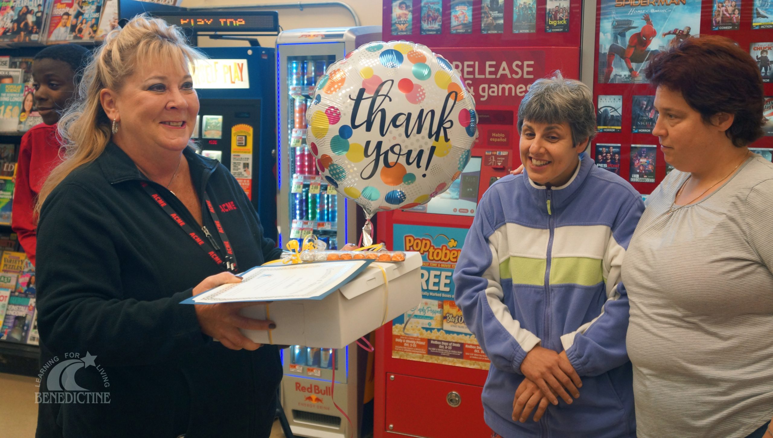 Members of Benedictine's Adult Services giving balloon and cake to Acme Store Director Susan Killen.