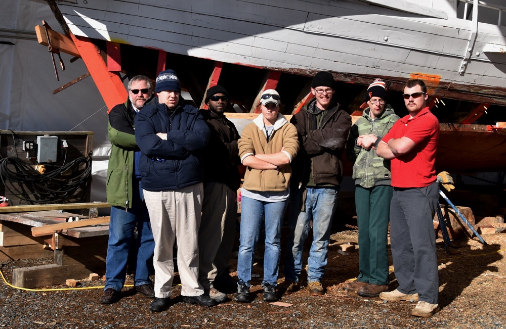 Yard Bee crew poses in front of boat yard at Chesapeake Bay Maritime Museum.