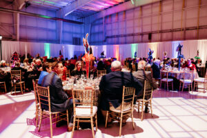 Attendees sit at their tables to eat dinner